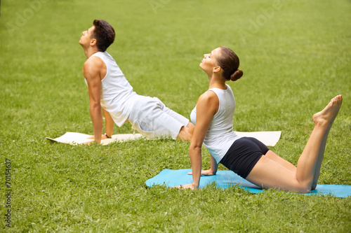 Fitness Exercise. Young couple training in Summer Park
