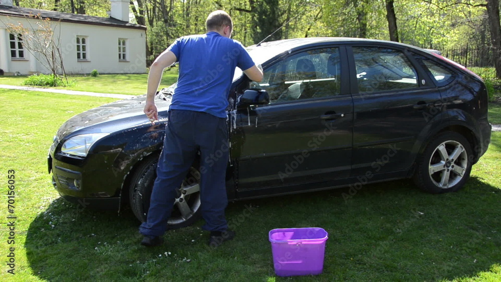 manual hand car wash cleaning with foam and sponge on open air. manual hand car wash cleaning with foam and sponge on open air.