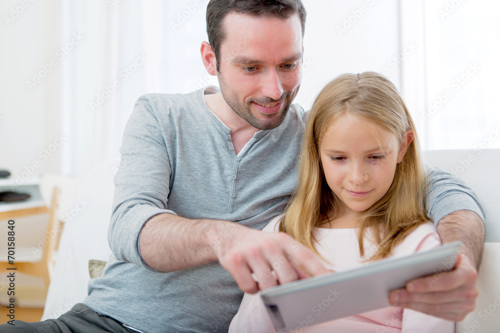 Father and his blond daughter using tablet Father and his blond daughter using tablet