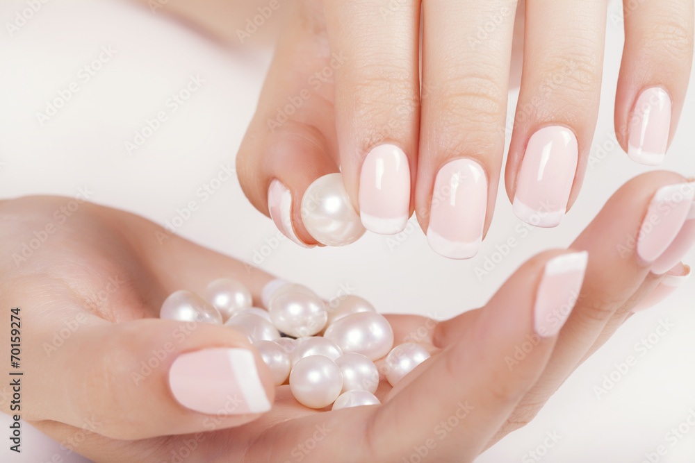 Beautiful woman's nails with french manicure and pearls. Beautiful woman's nails with french manicure and pearls.
