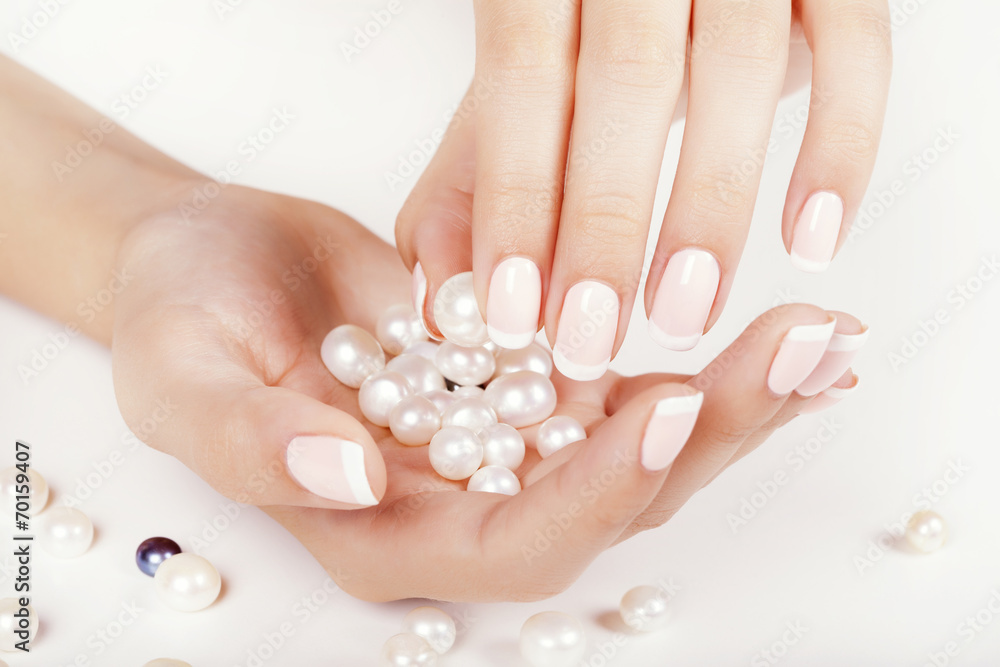 Beautiful woman's nails with french manicure and pearls. Beautiful woman's nails with french manicure and pearls.