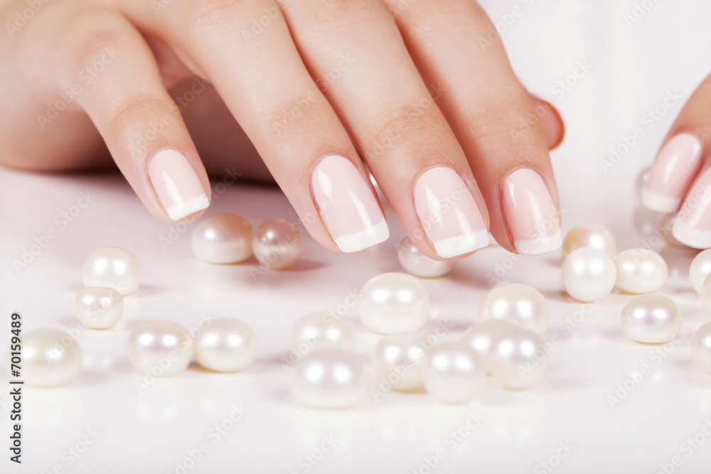 Beautiful woman's nails with french manicure and pearls. Beautiful woman's nails with french manicure and pearls.