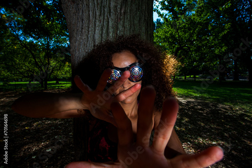 Young Brunette Hispanic woman wearing X-Ray glasses and making s photo