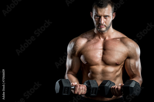 Man doing biceps curls in gym.