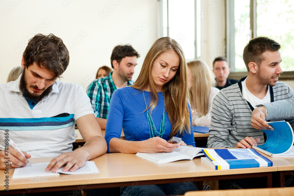 Students taking notes in a classroom Students taking notes in a classroom
