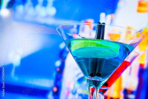 blue and red cocktail with lounge bar background