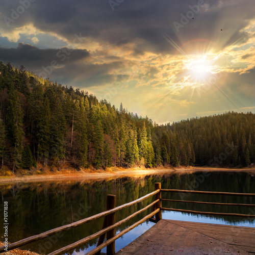 Fototapeta Naklejka Na Ścianę i Meble -  pine forest and lake near the mountain at sunset