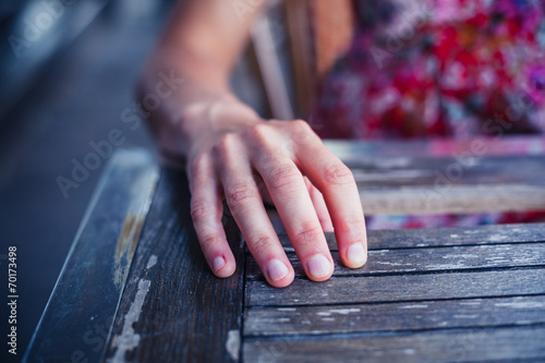 Woman resting hand on table