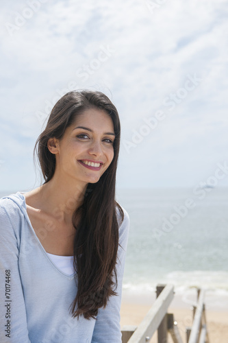 portrait of a beautiful woman before the sea in summertime
