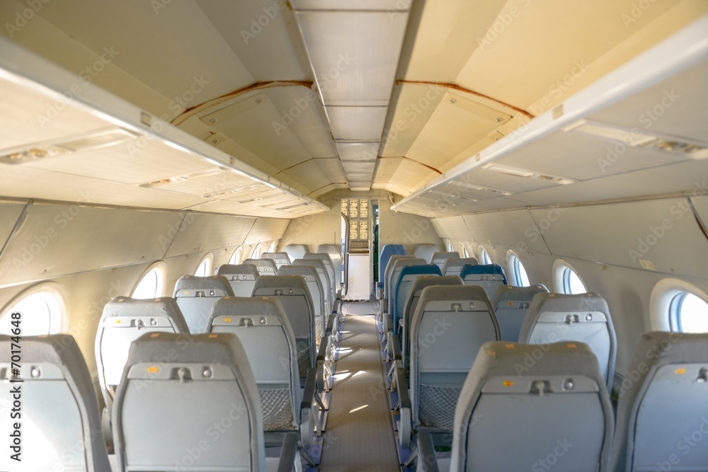 Interior of an airplane with many seats Interior of an airplane with many seats