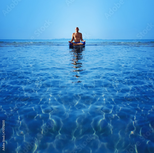 Man meditating upon the ocean