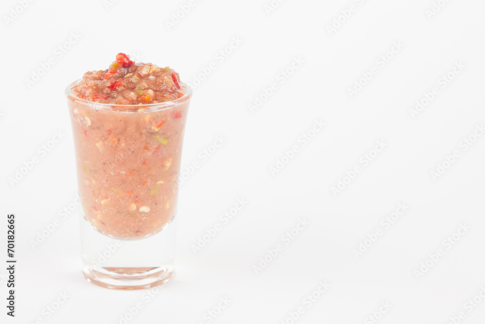 chili paste in glass on white paper background chili paste in glass on white paper background
