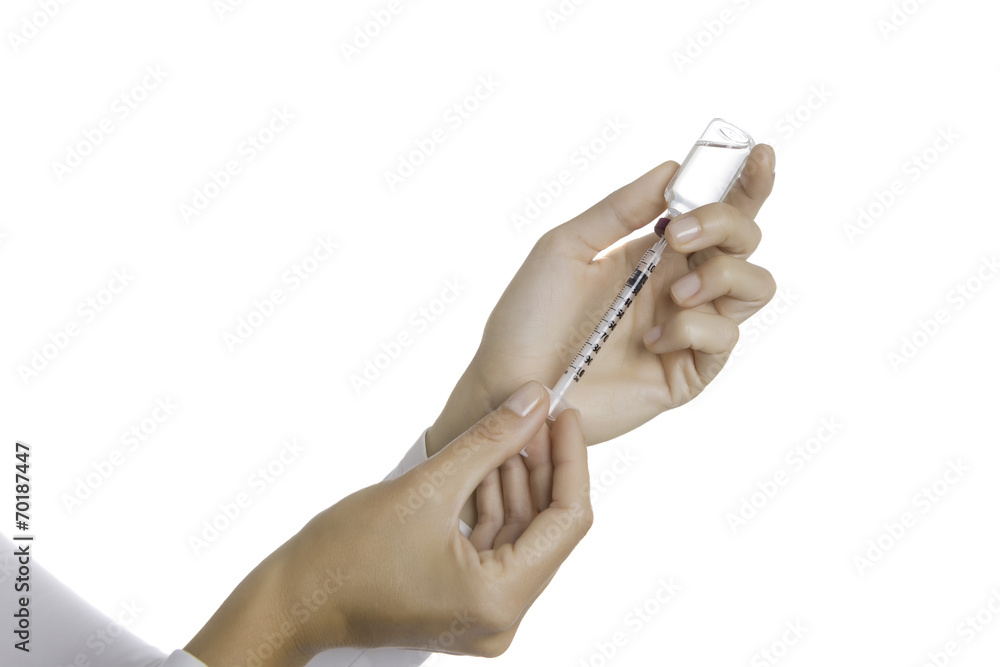 hands filling a syringe with an insulin vial hands filling a syringe with an insulin vial