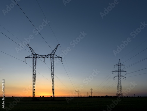 Large transmission towers at sunset