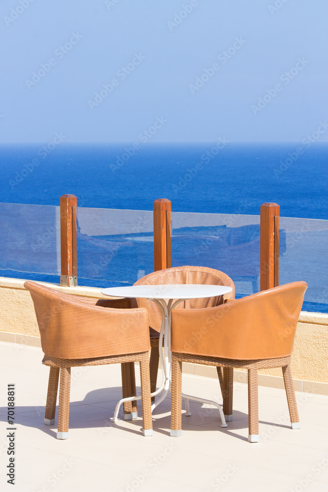 table and chairs on terrace with sea view