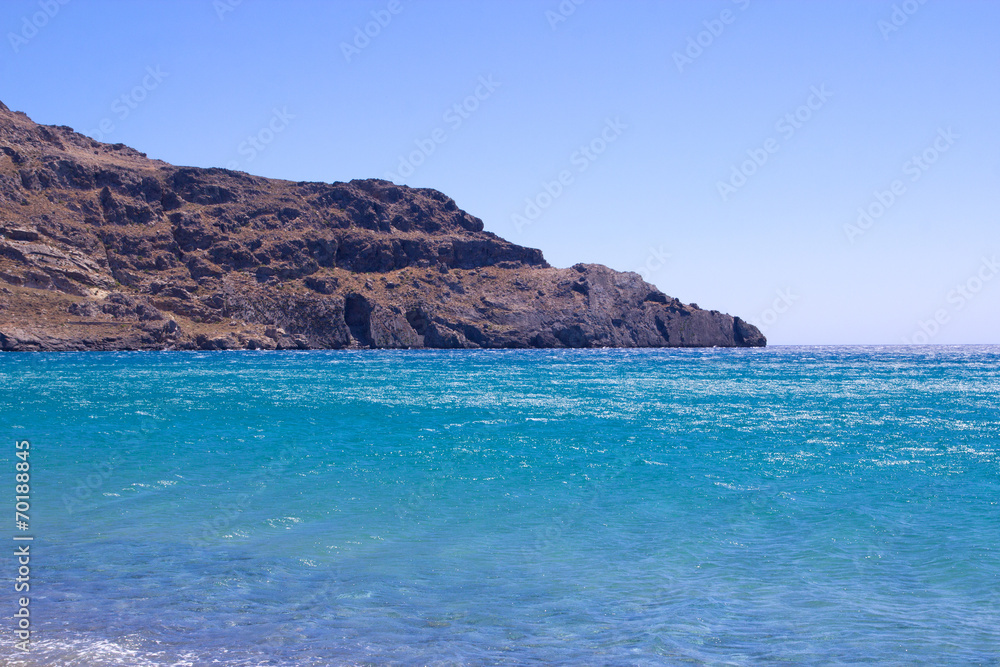 rocky cliff in blue transparent sea rocky cliff in blue transparent sea