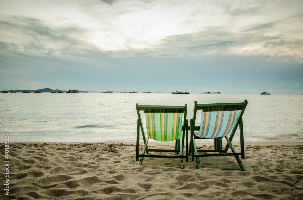 beach, two deck chairs and blue sky