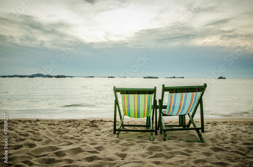 beach  two deck chairs and blue sky