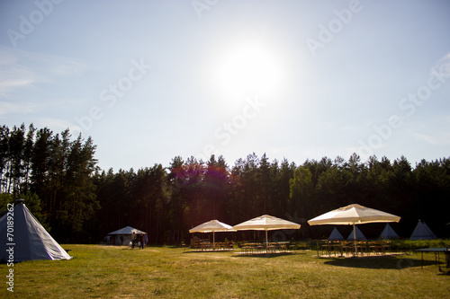 Tents in the tourist camp in a forest glade. © scadidi