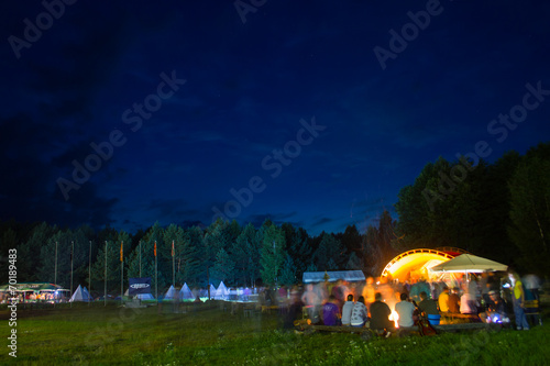 Night party near the fire in the forest.