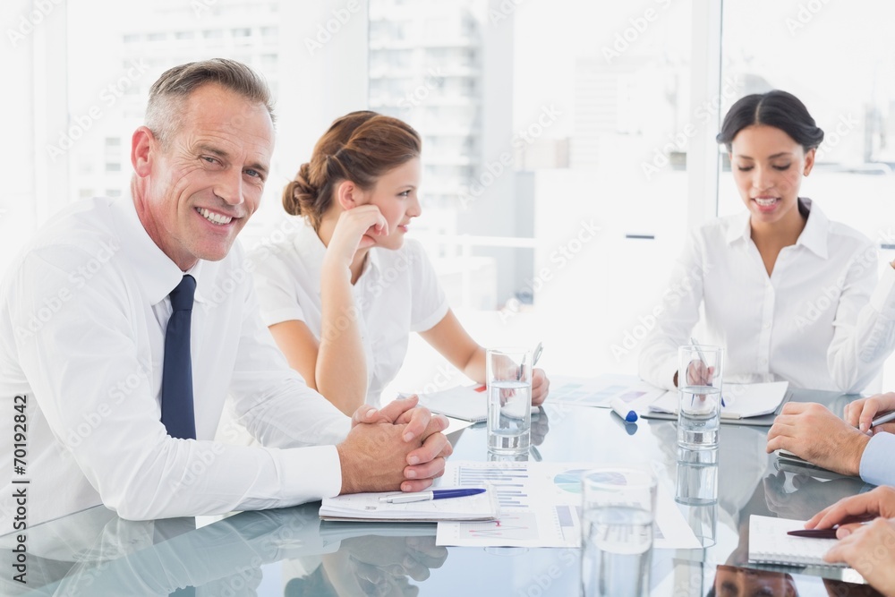 Businessman smiling in a meeting Businessman smiling in a meeting