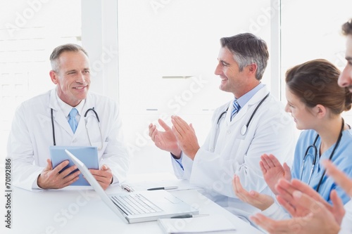 Doctors applauding a fellow doctor