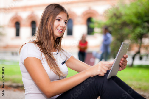 Free Download Smiling student using a tablet - GFXLoad