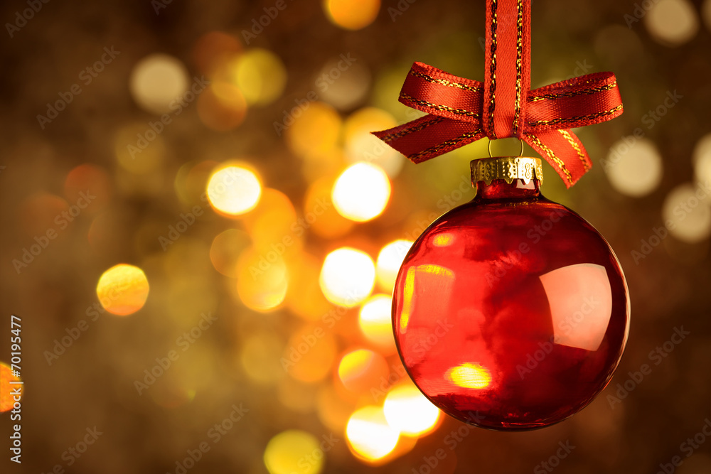 Christmas red bauble over magic bokeh background