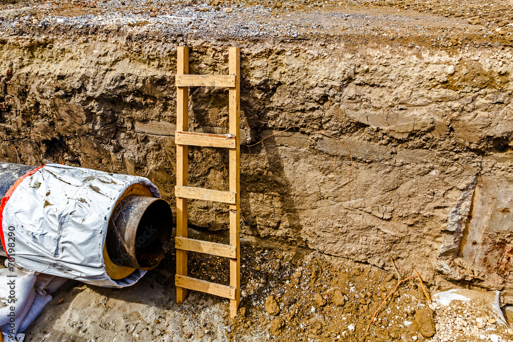 Wooden ladder in a fresh trench, layers of soil Stock Photo Adobe Stock