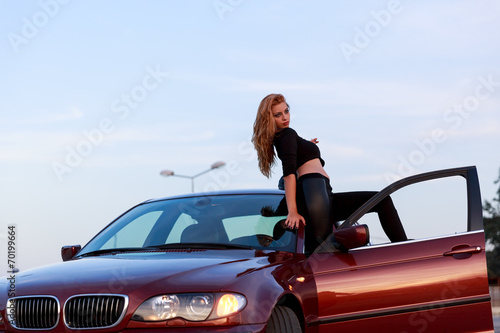 Young pretty lady with a clasic car