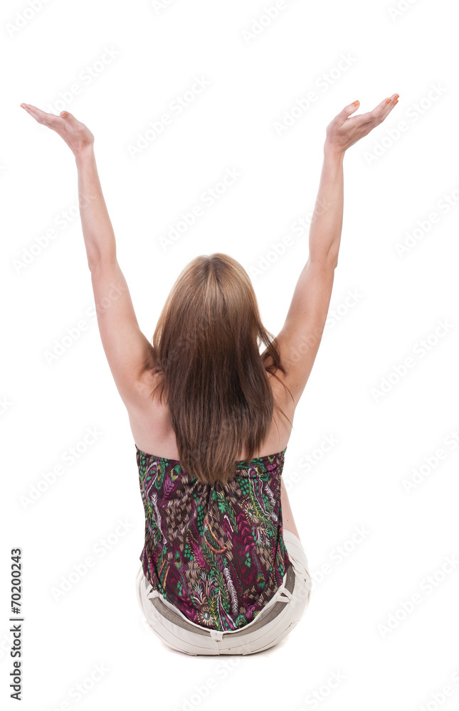 Back view of Beautiful woman in jeans looking at wall and Holds Back view of Beautiful woman in jeans looking at wall and Holds