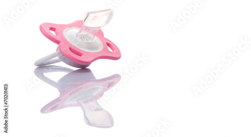 A pink pacifier over white background