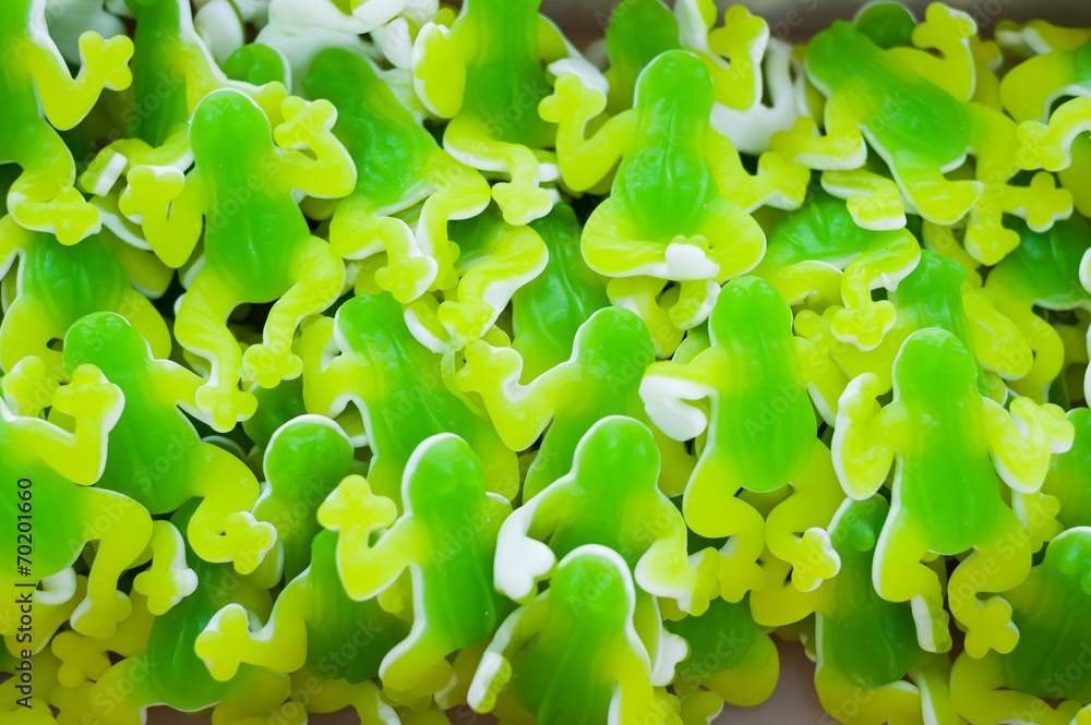 Green jelly candies in the form of frogs on the counter