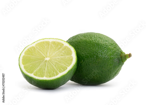 Limes with slices isolated on white background
