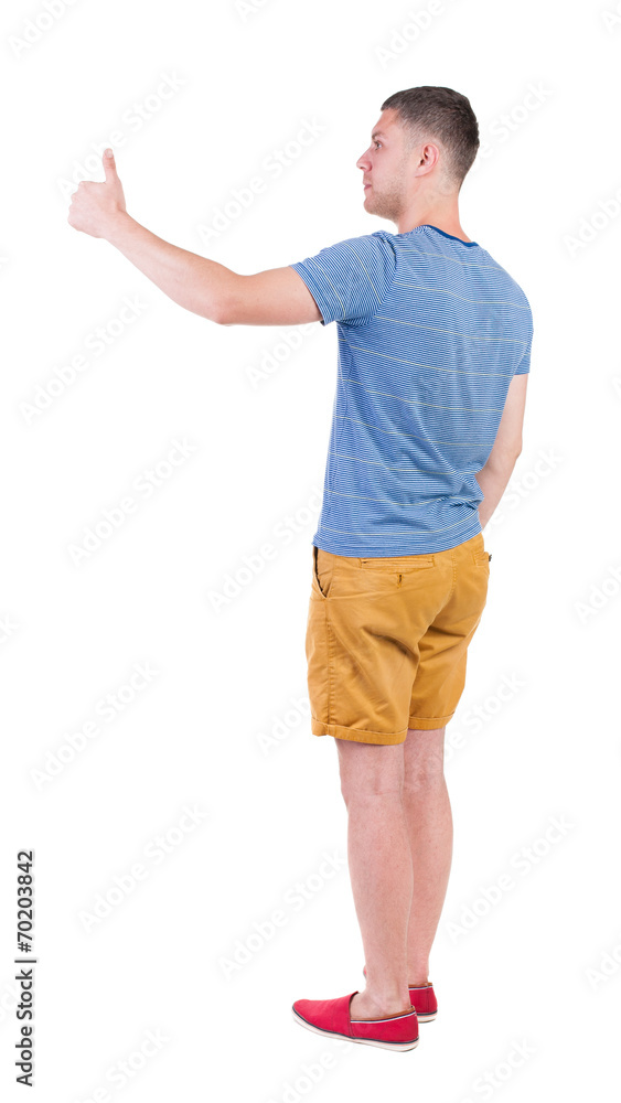 Back view of man in checkered shirt shows thumbs up. Back view of man in checkered shirt shows thumbs up.