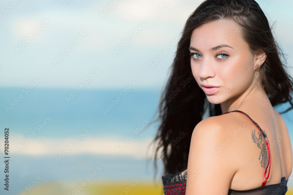 Portrait of beautiful young brunette with tattoo Portrait of beautiful young brunette with tattoo