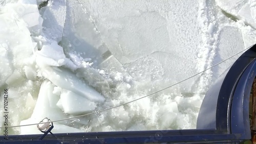 View down the side of an icebreaker while it breaks ice