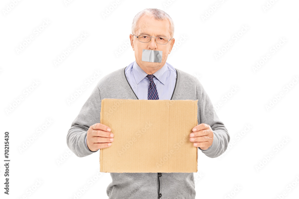 Senior with duct taped mouth holding a blank sign Senior with duct taped mouth holding a blank sign