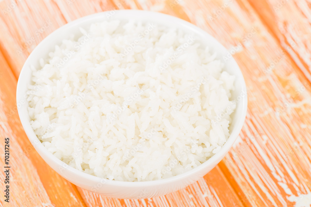 Steamed Rice - Boiled rice in a bowl on an orange background. Steamed Rice - Boiled rice in a bowl on an orange background.
