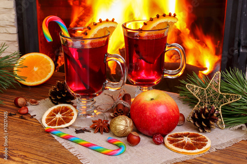 Christmas mulled wine - two glasses on the background of a burni photo