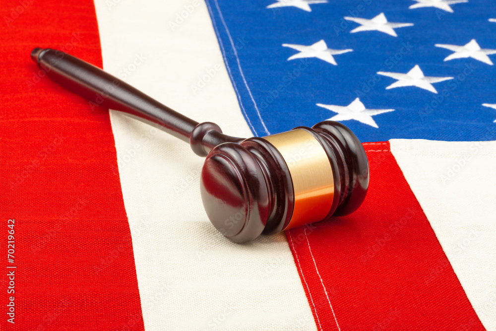 Wooden judge gavel over US flag - closeup studio shot