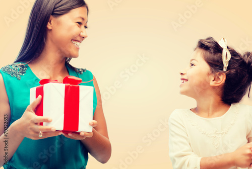 happy mother and child girl with gift box