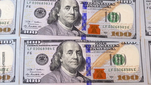 pan view over 100 dollar bills