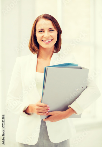 businesswoman with folders in office