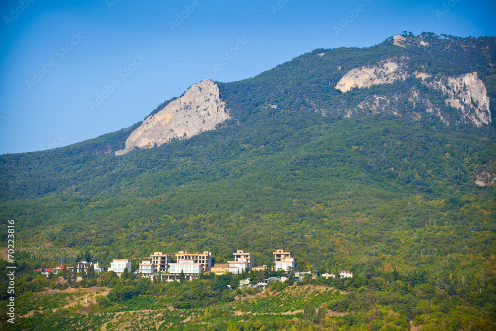 Crimean mountain landscape. Green trees, Dwelling houses
