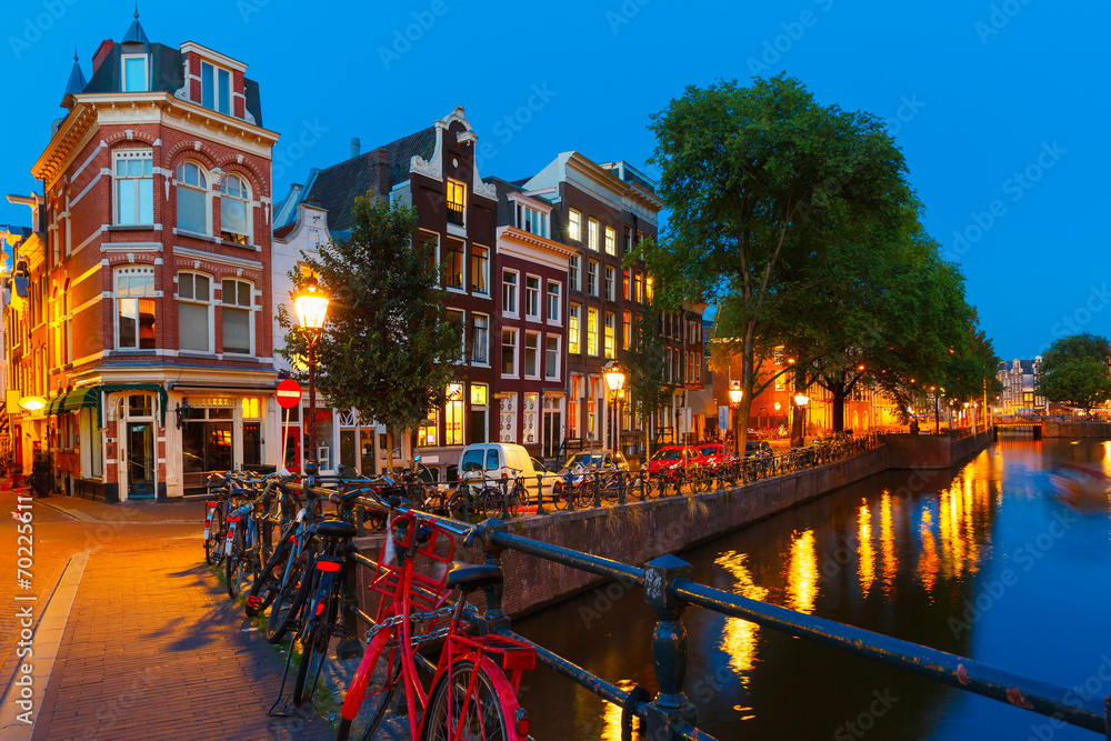 Night city view of Amsterdam canal and bridge