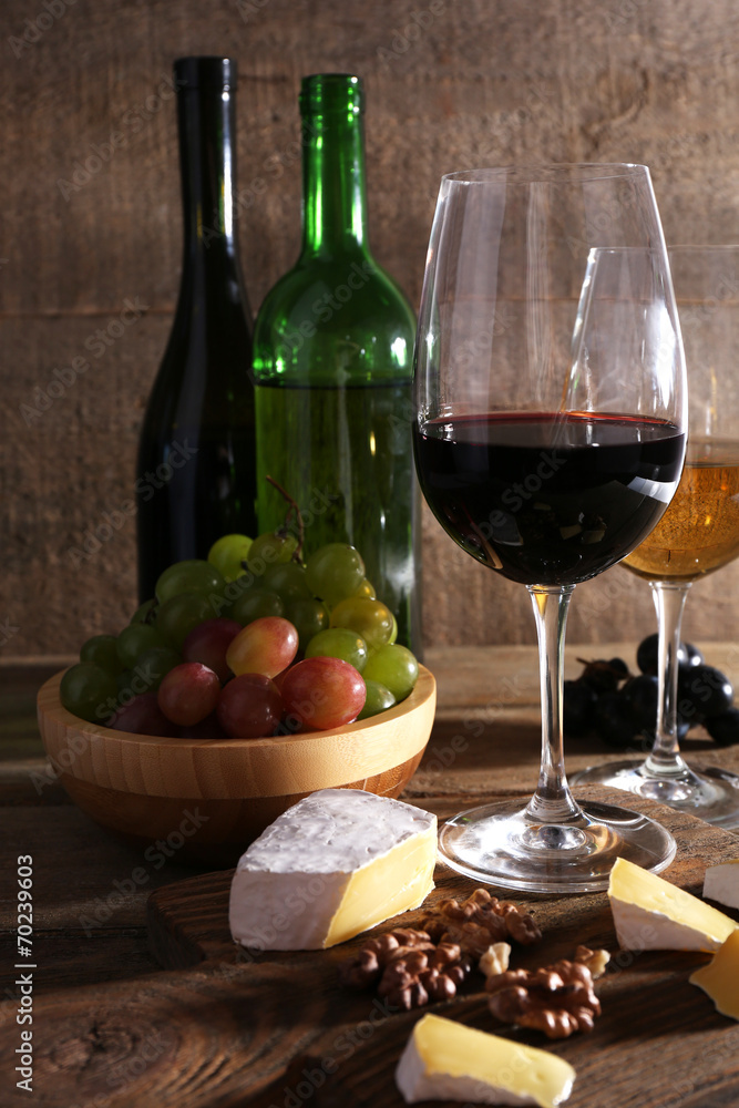 beautiful still life with wine, cheese and ripe grape