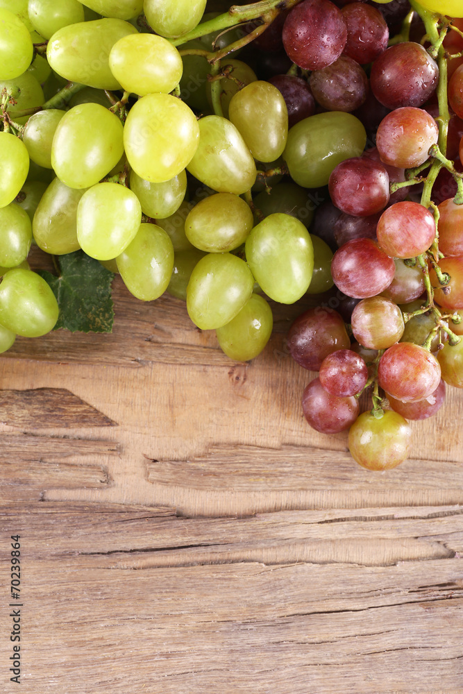 Bunches of grapes on wooden background Bunches of grapes on wooden background