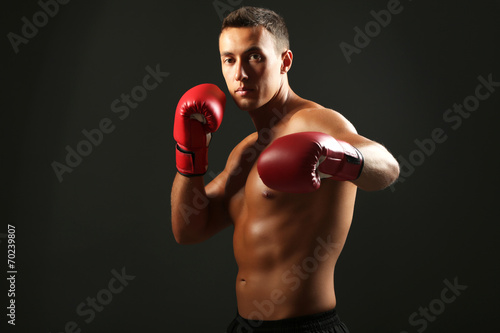 Handsome young muscular sportsman with boxing gloves © Africa Studio