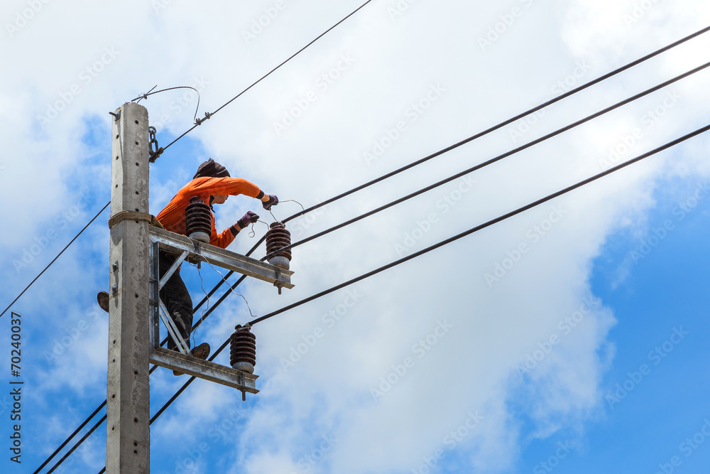 electrician working repairing wire on electric power pole electrician working repairing wire on electric power pole
